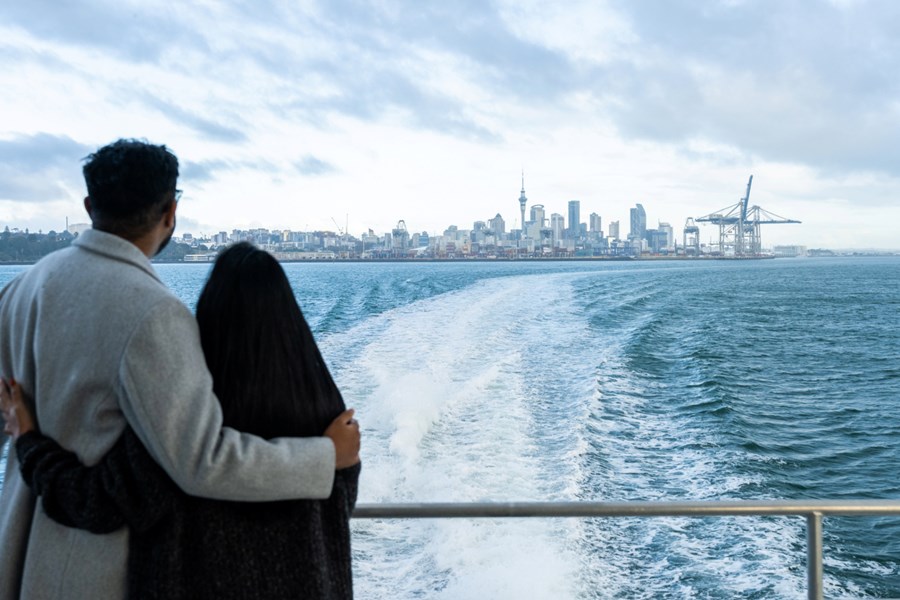 Couple hugging on the ferry looking out to Auckland city.jpg