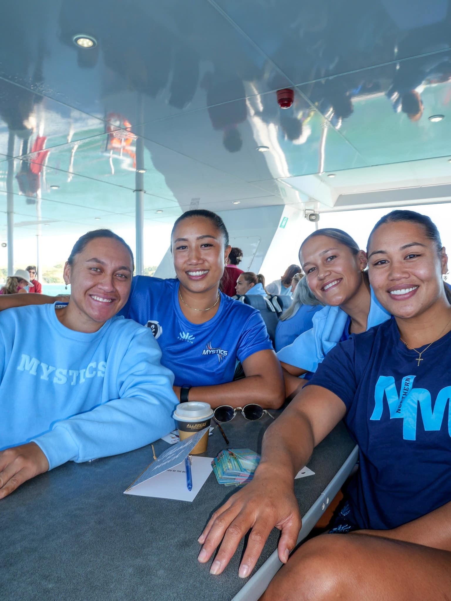 Northern Mystics team members sitting on Waiheke ferry