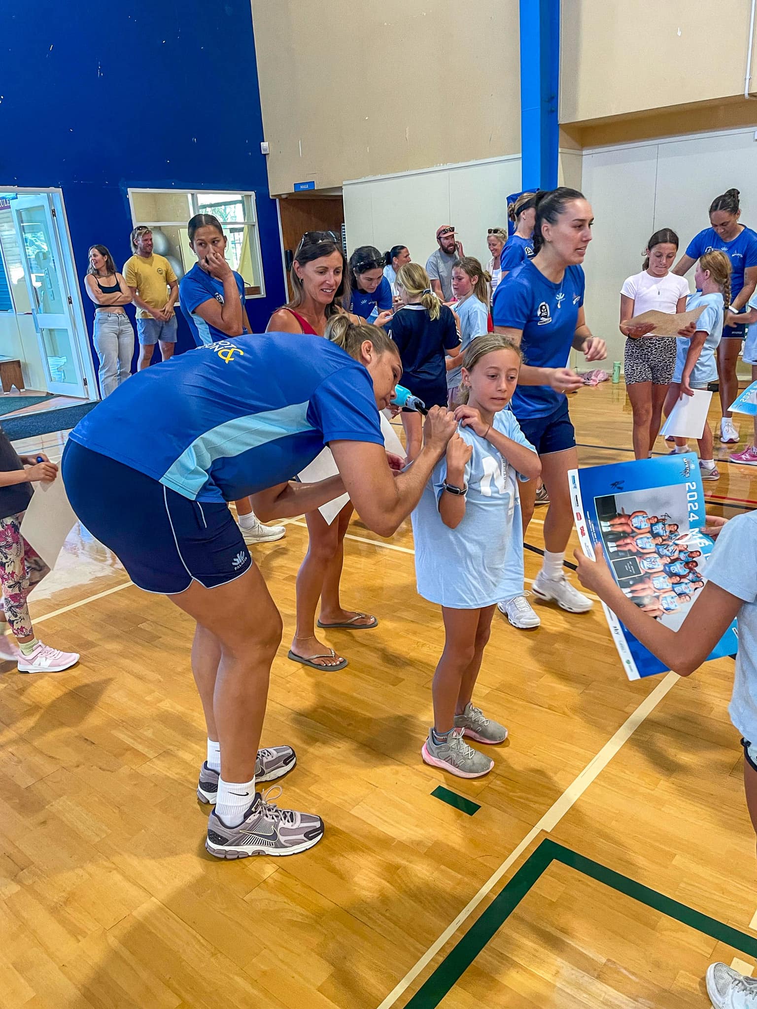 Northern Mystics team member helping child