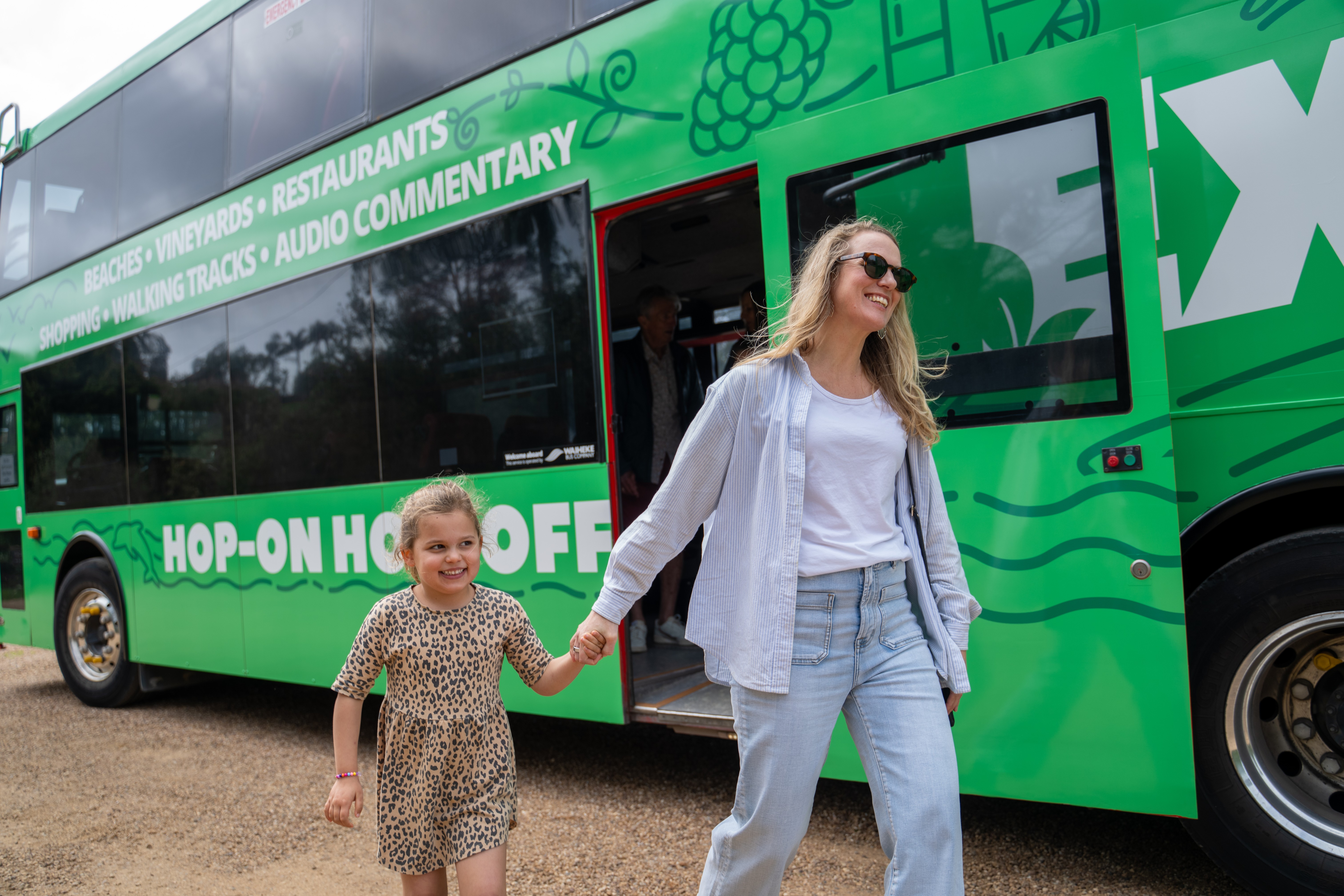 Mother and daughter stepping off Waiheke Island hop-on hop-off bus for a relaxing Mother’s Day outing